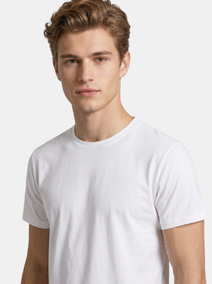 Man wearing a plain white t-shirt against a light background